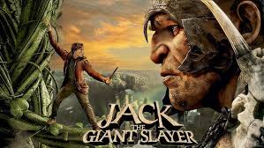 "A scene from 'Jack the Giant Slayer' showing Jack (Nicholas Hoult) holding a sword, standing bravely against a towering giant in a misty forest. The giant has rough, weathered skin and fierce eyes, while Jack wears a determined expression, ready for battle."