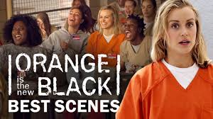 "Promotional poster for the TV series Orange Is the New Black (2013), showing an ensemble cast of diverse women in orange prison uniforms, standing against a white background. The show's title appears in bold black letters at the top."