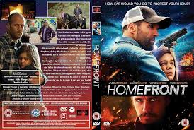 Jason Statham as Phil Broker, a rugged former DEA agent in a leather jacket, stands protectively in front of a wooden house at dusk, his expression tense. Behind him, his young daughter Maddy peers out nervously. In the foreground, James Franco as Gator Bodine smirks with a shotgun slung over his shoulder, flanked by two armed accomplices. The Louisiana bayou stretches behind them, with Spanish moss hanging from gnarled trees and the orange glow of sunset reflecting off swamp water, creating a moody, dangerous atmosphere.