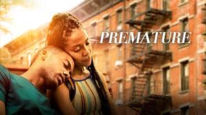 "Striking poster for Premature shows Ayanna (Zora Howard) and Isaiah (Joshua Boone) embracing intimately in a Harlem alleyway at golden hour. Sunlight filters through fire escapes as their silhouettes blend together, with the title in handwritten script above them. The muted color palette emphasizes the film's poetic realism."