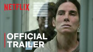 "Sandra Bullock as Ruth Slater stares intensely with weathered face and short, messy hair, her blue work shirt blending into a foggy gray background. The title The Unforgivable appears in cracked white letters, with Viola Davis and Jon Bernthal's names listed below."