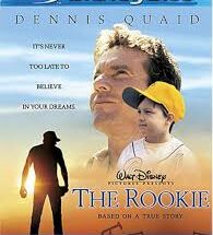 "Dennis Quaid as Jim Morris stands on a minor league baseball mound at sunset, wearing a faded Orlando Rays uniform. The golden light highlights his determined expression as he grips a baseball, with the tagline 'It's Never Too Late To Believe' superimposed over a blurred baseball field background."