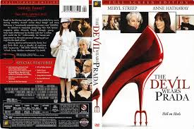 *"Anne Hathaway as Andy Sachs, a young journalist, stands beside Meryl Streep as Miranda Priestly, the intimidating editor-in-chief of Runway magazine, in a sleek office. Andy holds a binder while Miranda, dressed in a sharp white outfit and sunglasses, exudes authority. The scene captures the high-fashion, high-pressure world of the iconic 2006 film."*