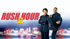 *"Jackie Chan and Chris Tucker in 'Rush Hour 2' (2001), standing back-to-back in action poses, wearing casual clothes. Behind them, a vibrant Hong Kong cityscape with neon signs sets the scene for this action-comedy sequel."*